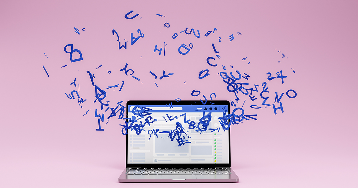 Laptop with floating blue letters on a pink background.