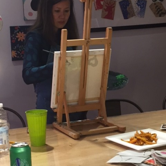 Sandy Wong focused on painting at a team bonding event.