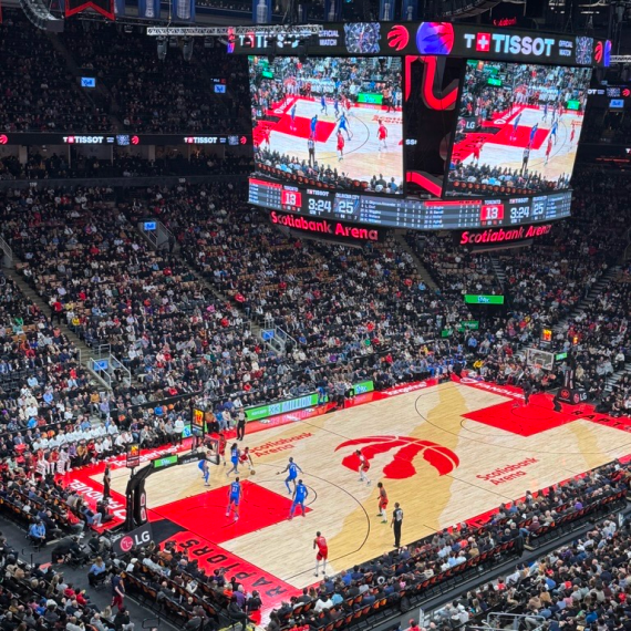 Wide-angle view of Scotiabank Arena during a basketball game, featuring a packed audience and players on the court.