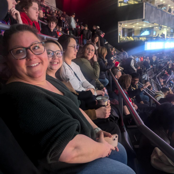 Group of team members enjoying a Toronto Raptors game from the stands.