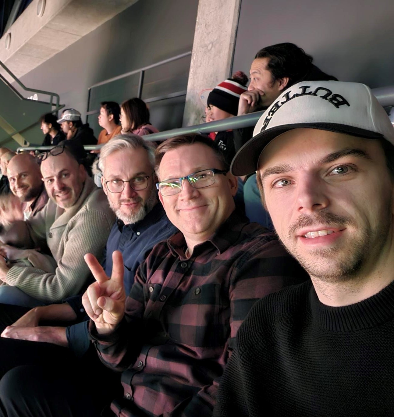 Group of colleagues taking a selfie at a Raptors game.